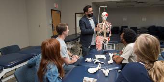 Professor teaching using skeleton