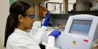 person working on machine in a lab