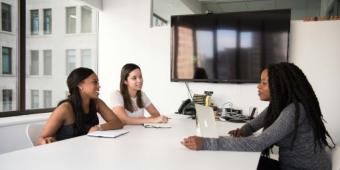 People talking at a desk