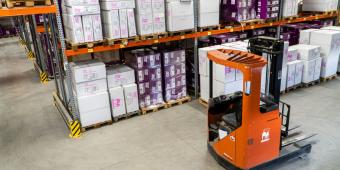 warehouse with boxes and an orange forklift